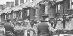 British soldiers look on at burned out houses in Belfast in the early years of the Troubles.