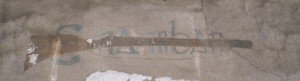 Graffiti with the initials of Cumman na mBan and a rifle in Kilmianham Gaol.
