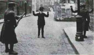 Free State troops search a civilian suspect in Dublin, 1922.